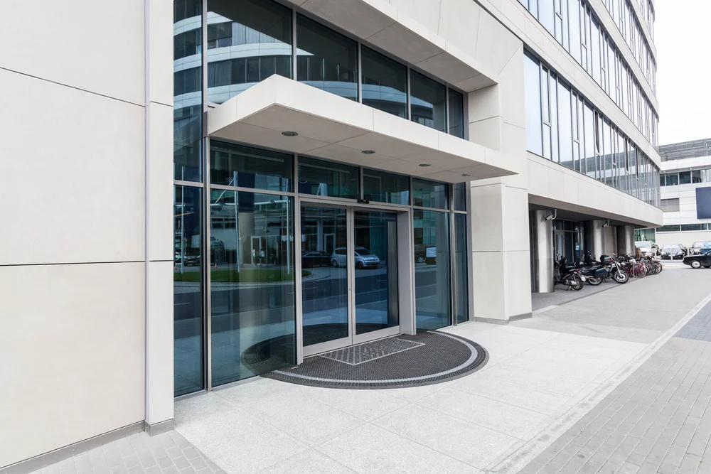 https://onedoor.com/wp-content/uploads/2025/02/Door-of-a-new-contemporary-office-building.webp