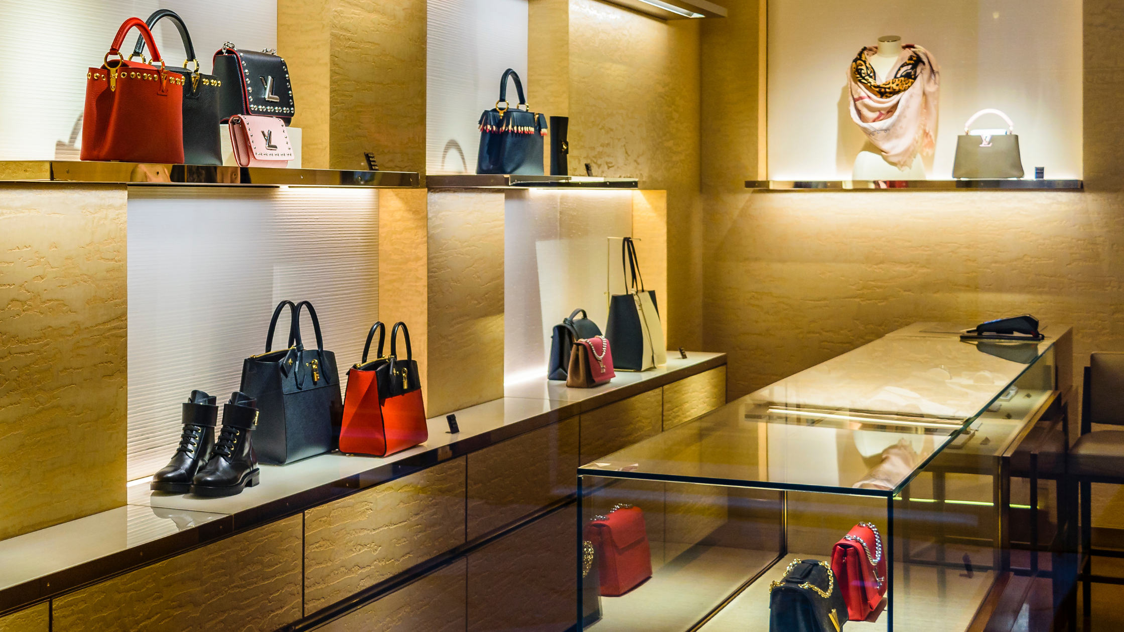 A meticulously organized set of shelves with luxury purses